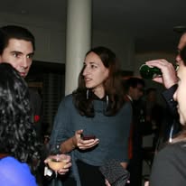 Independent consultants talking at an evening networking event
