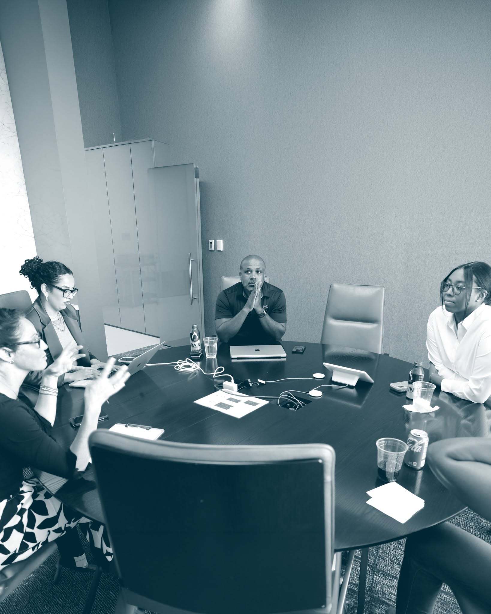 A consultant presenting to prospective clients in a boardroom meeting
