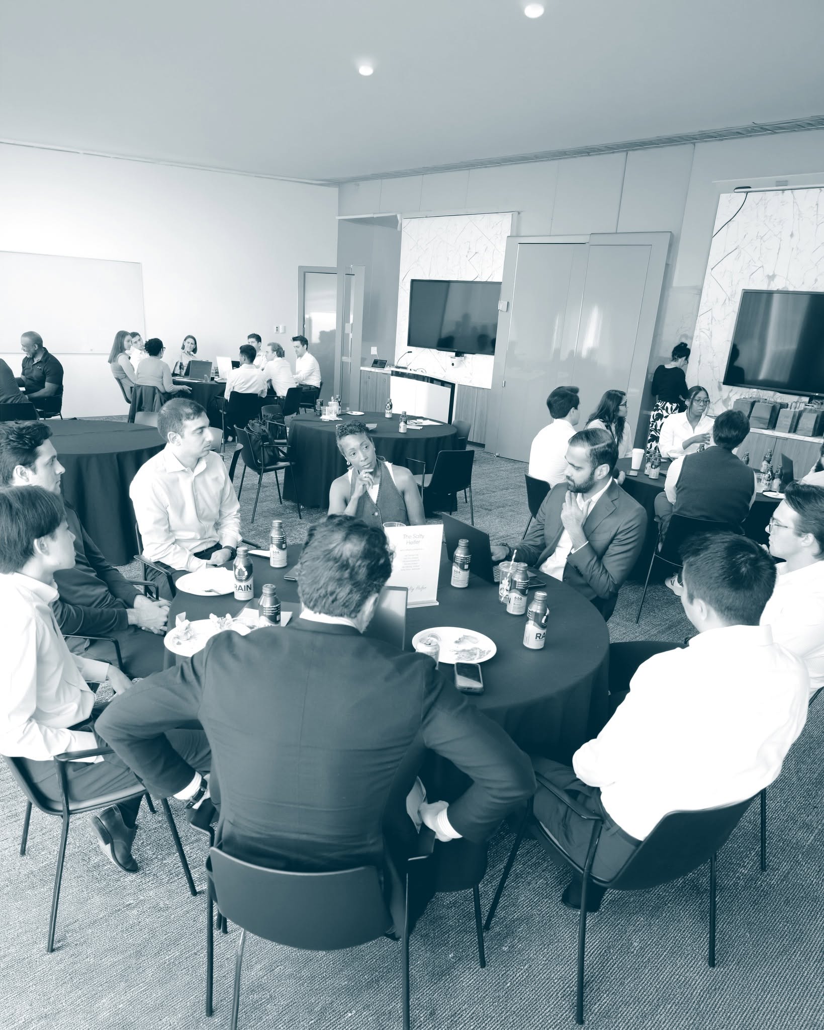 Consultants meeting prospects at a business networking event, where a consulting portfolio shapes the first impression
